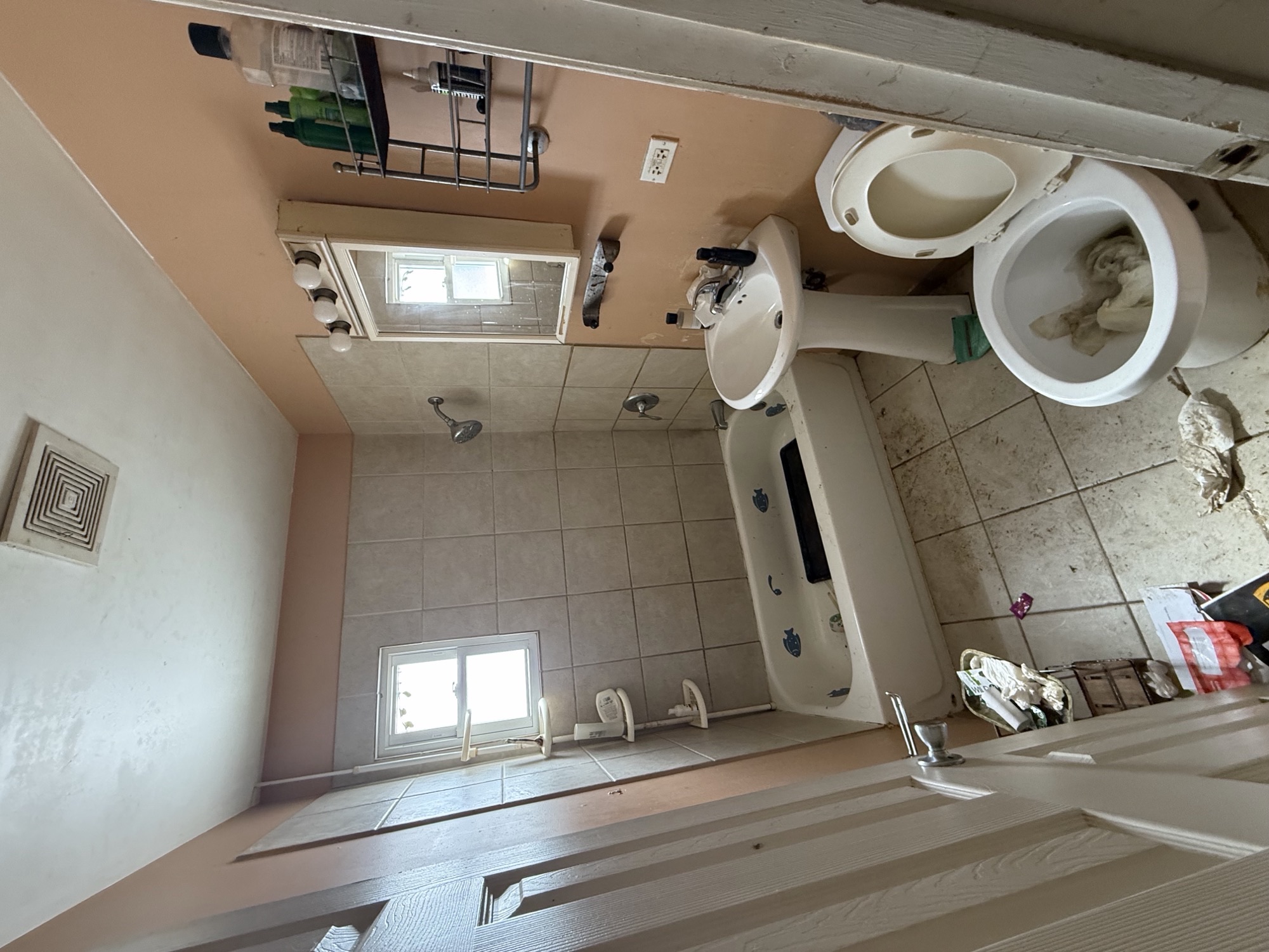 Naperville bathroom before the Lake & Oak update, showing the existing tub, wall tile, and pedestal sink